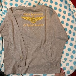 A gray t-shirt with 100th Navel Aviation shirt.